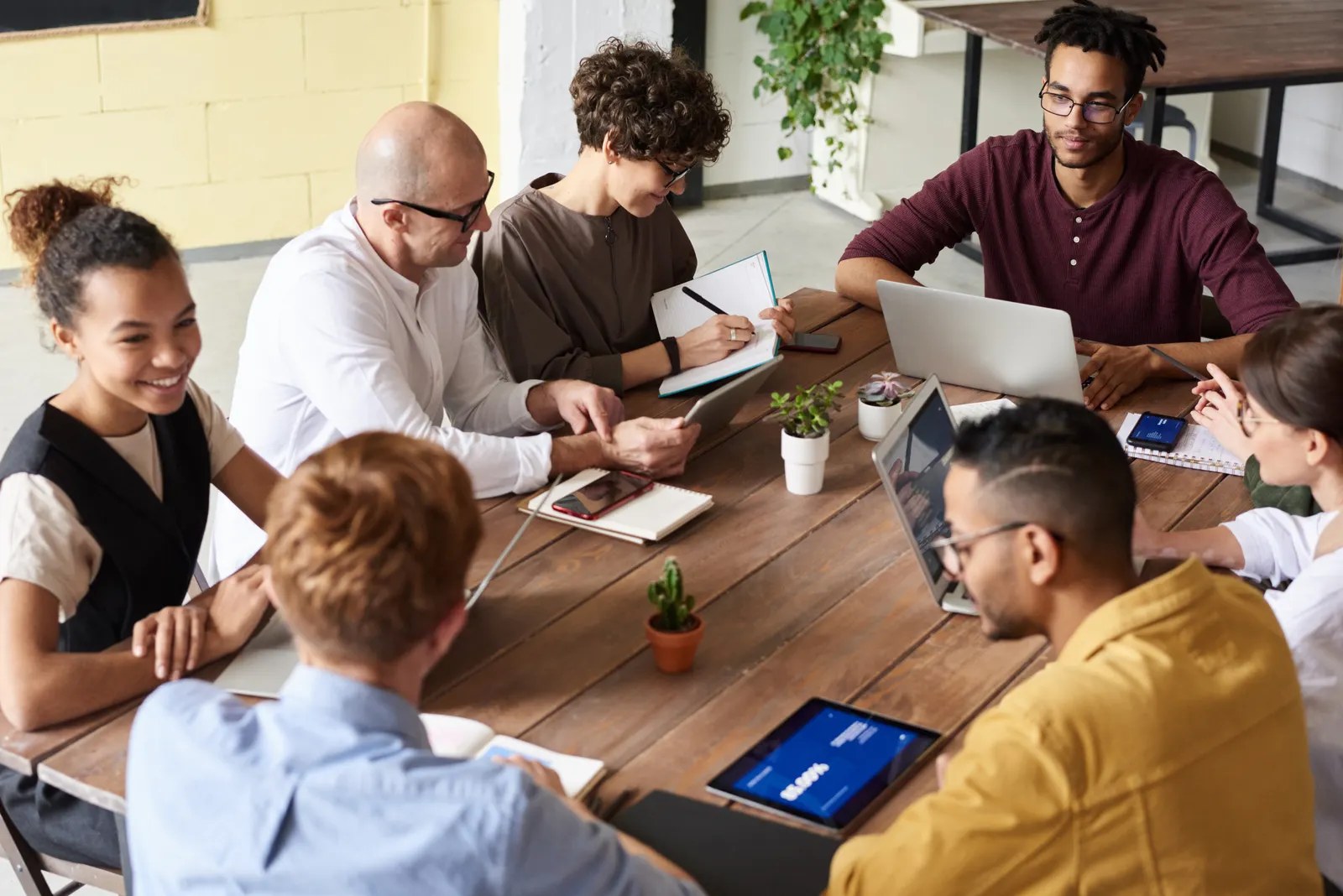 The Previously editorial team planning coverage around a table