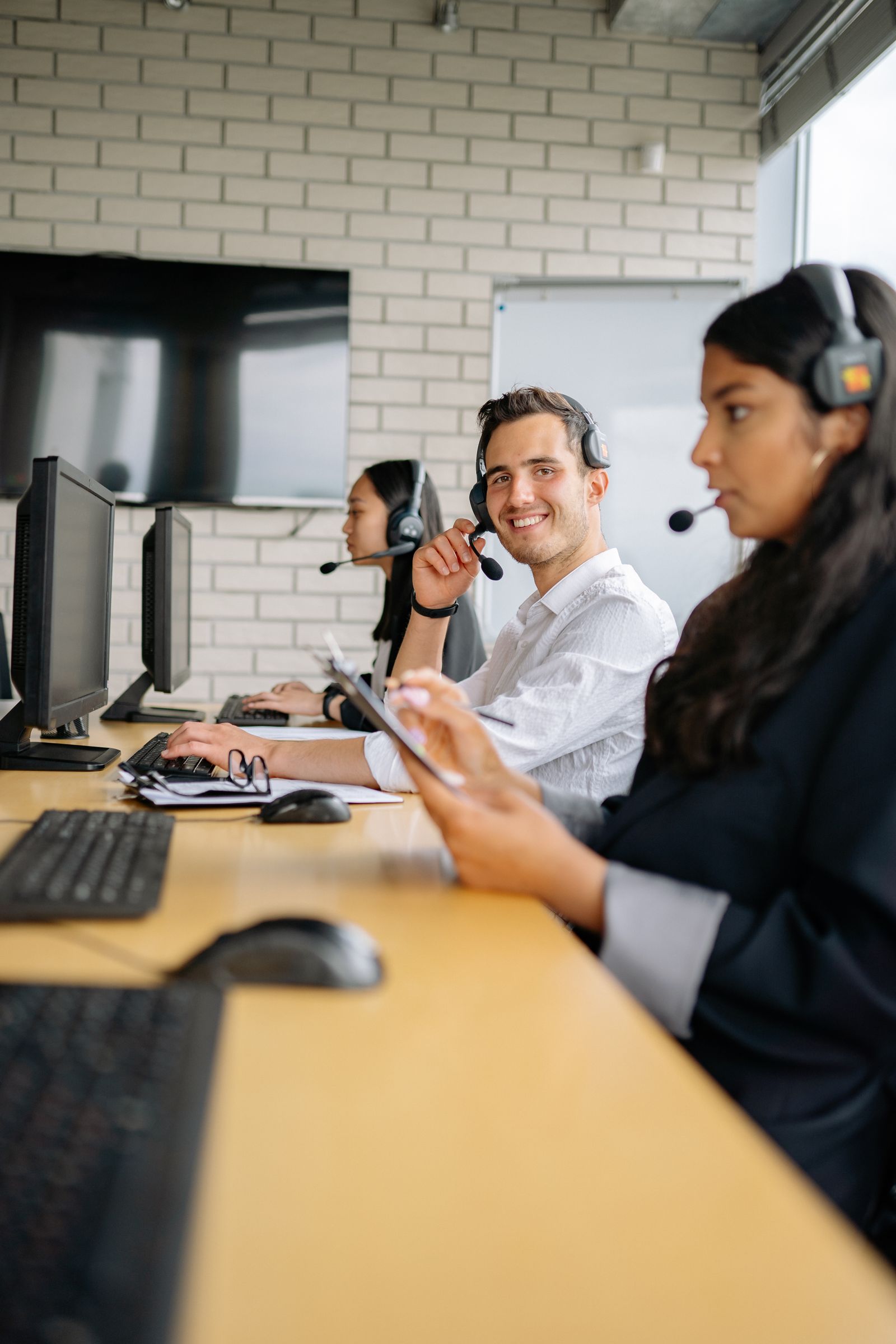 Customer support specialists with headsets, ready to help