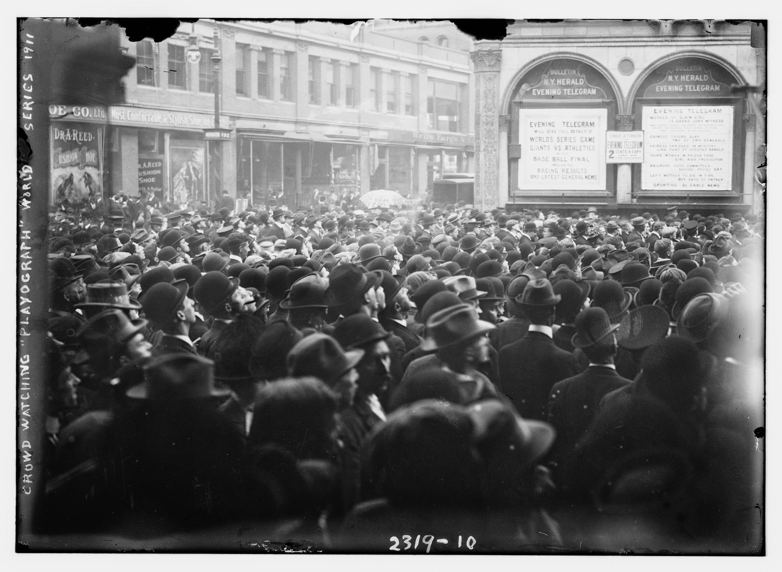 A huge Herald Square crowd gathered around an electromechanical playograph scoreboard during the 1911 World Series