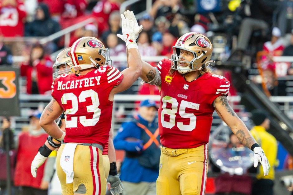 Christian McCaffrey (23) and George Kittle (85) of the San Francisco 49ers celebrate.
