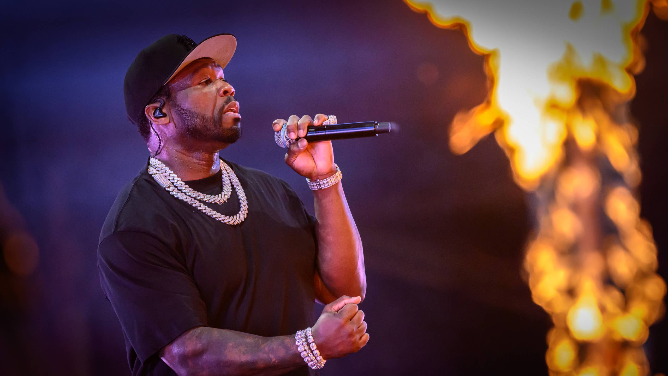 50 Cent performing on stage at Tottenham Hotspur Stadium in 2025