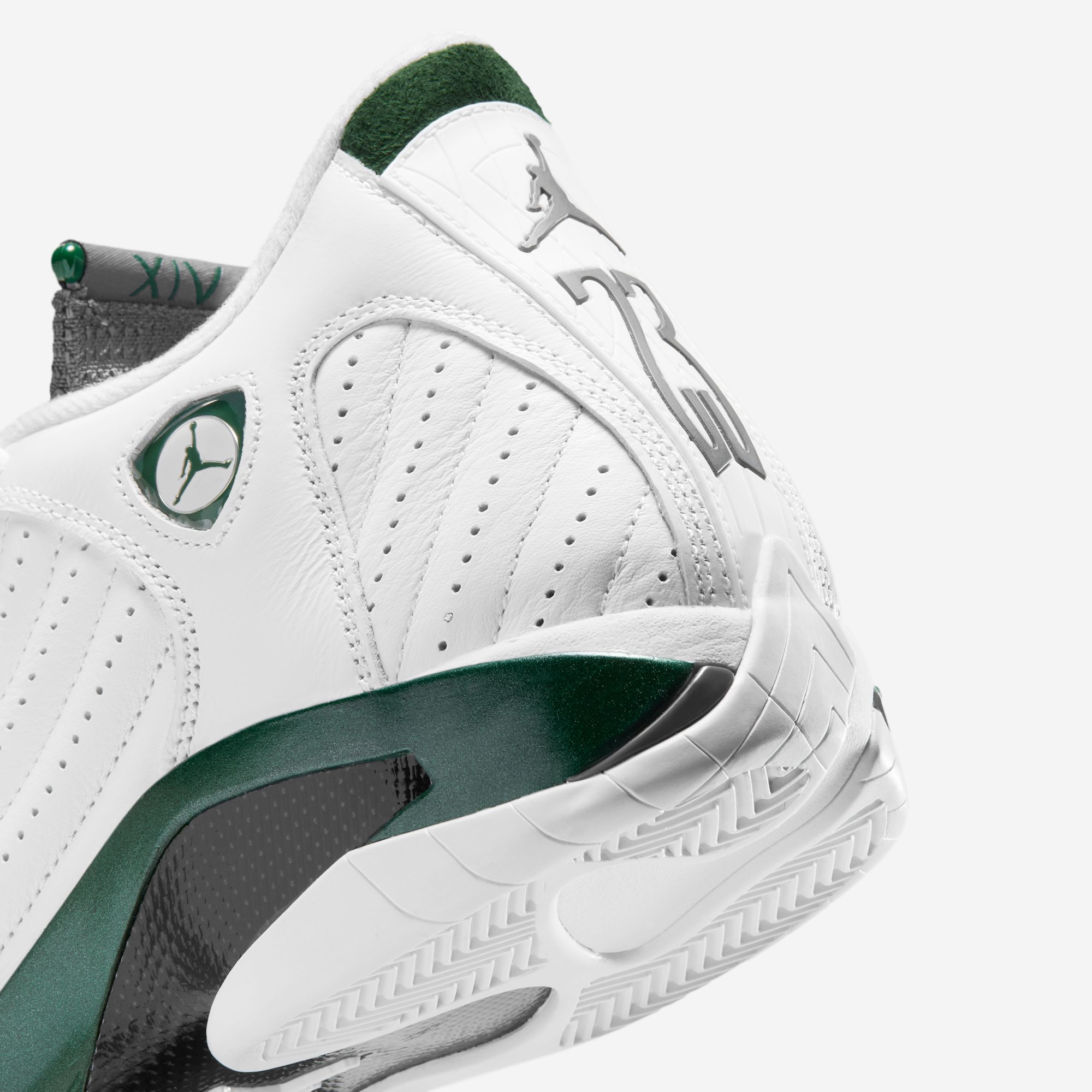 Heel close-up of the “Forest Green” 14 — the shield badge with its Jumpman, the metallic 23 down the heel, the green XIV jewel on the tongue, the carbon shank meeting the green midsole