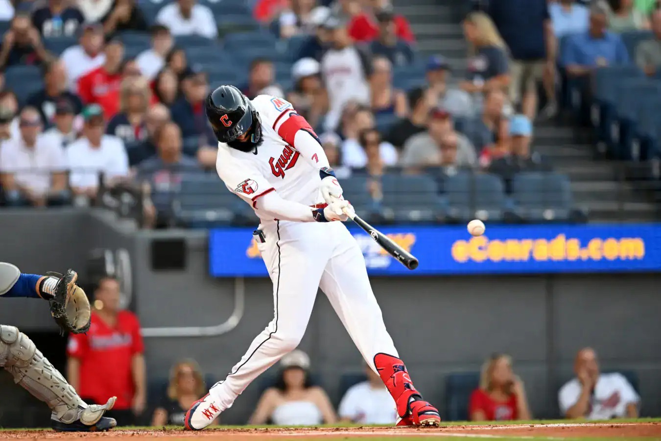 Jose Ramirez swings for the Cleveland Guardians in his home whites