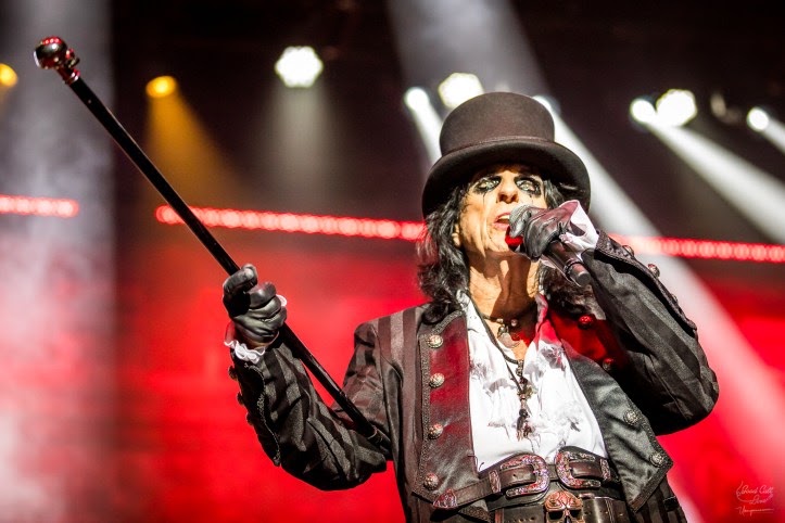 Alice Cooper performing live on stage, in full theatrical regalia.