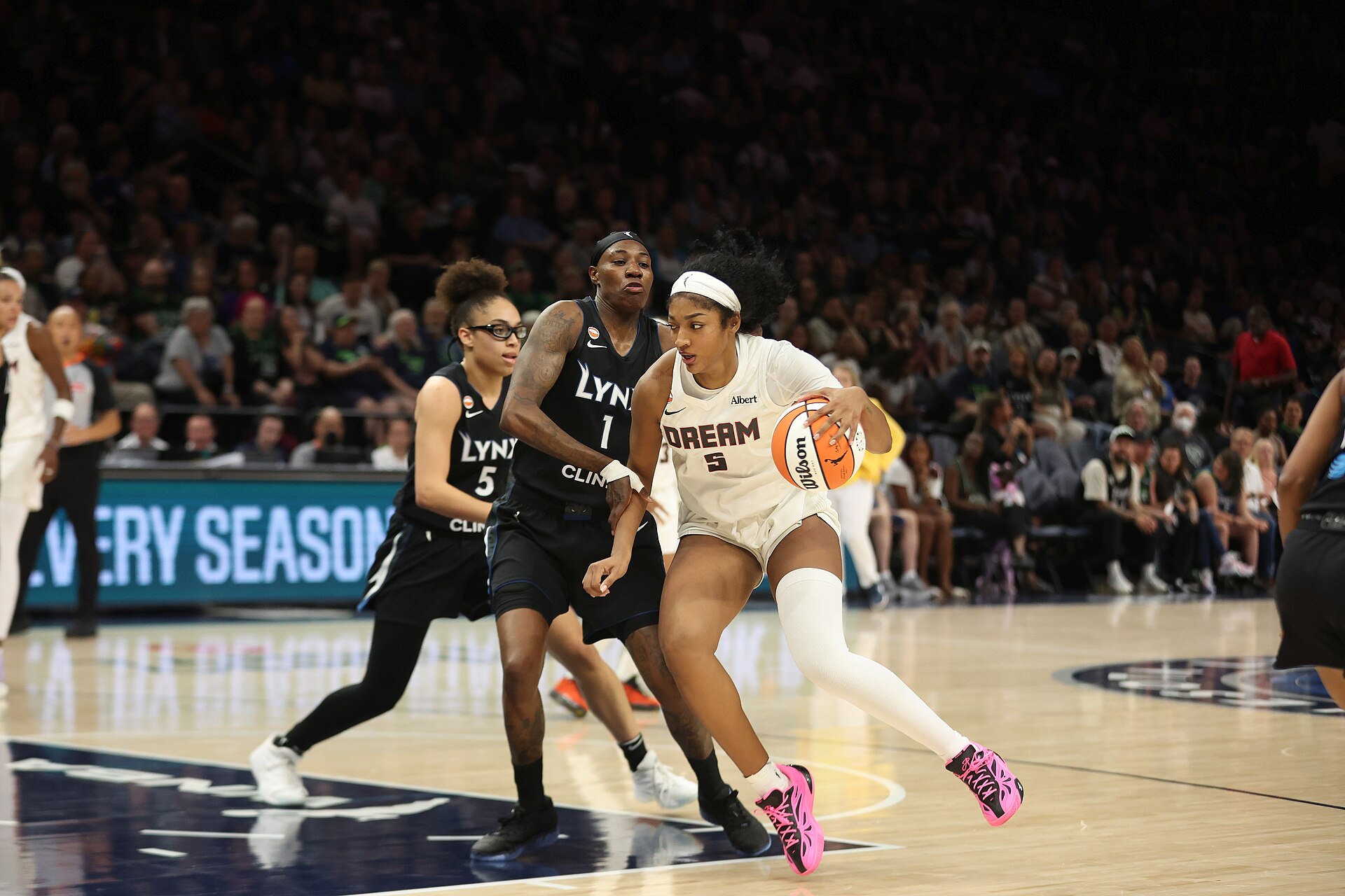 Angel Reese drives past Minnesota Lynx defenders for the Atlanta Dream at Target Center on May 27, 2026