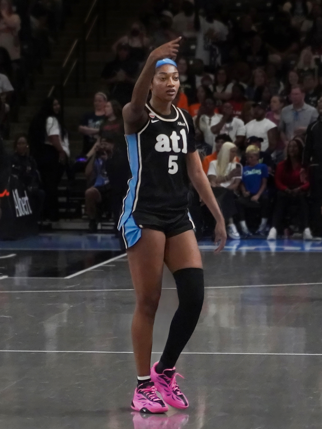 Angel Reese in Atlanta's black uniform, pointing up court during a Dream game in May 2026