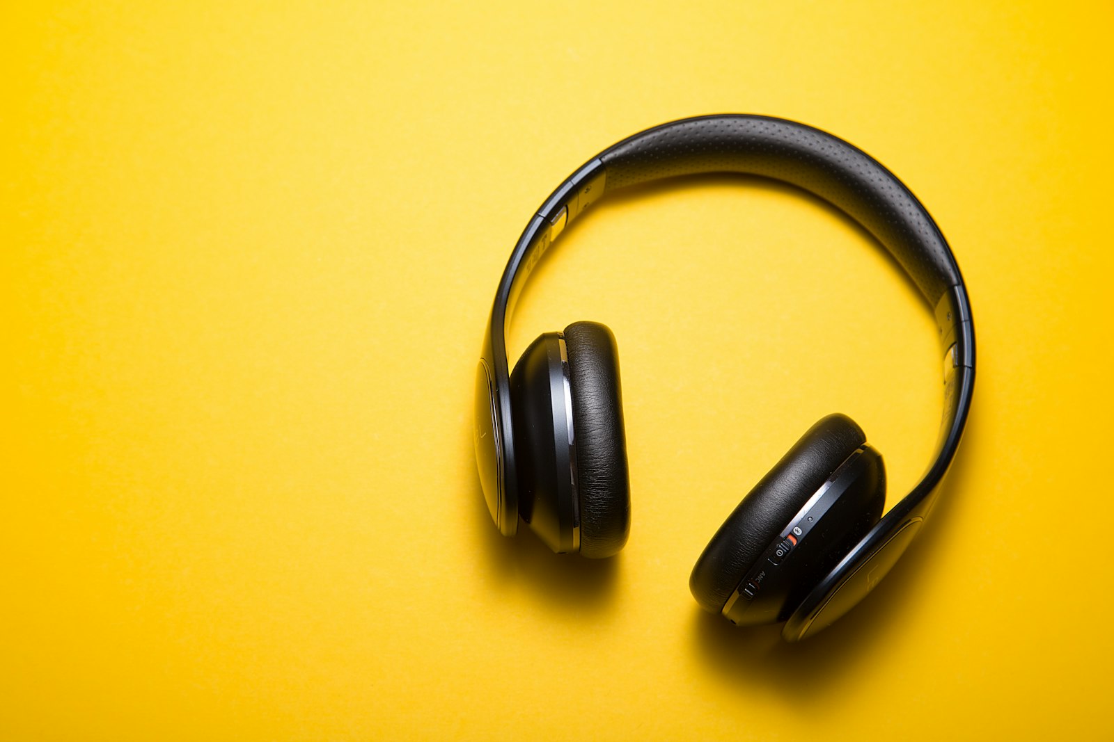 Headphones resting on a bright surface, ready for listening