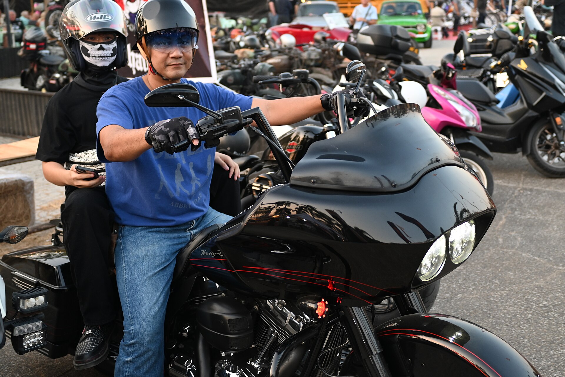 Motorcycle riders wearing helmets in bright daylight