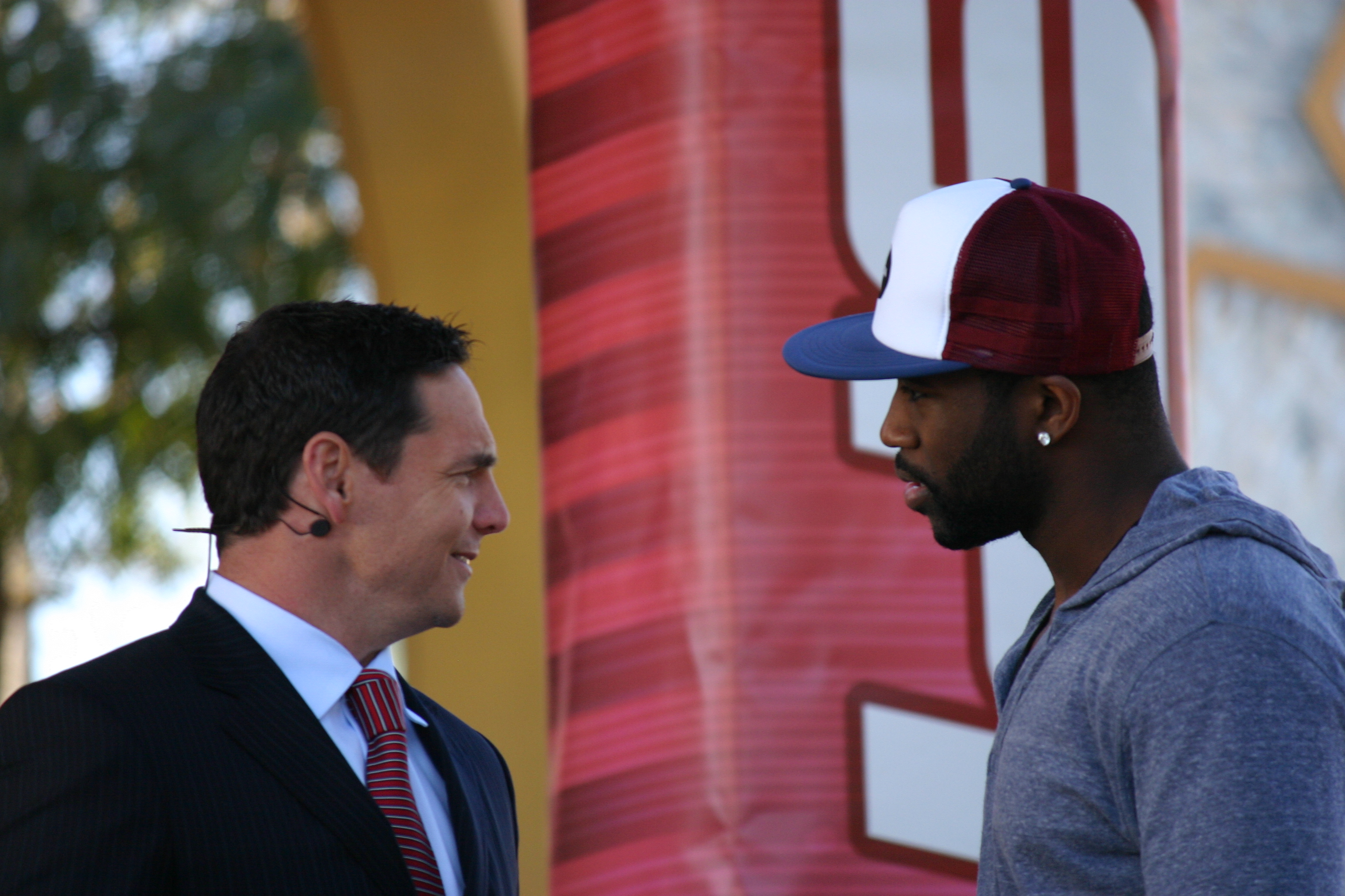 Jay Feely, left, talks with Darrelle Revis during a 2010 ESPN broadcast