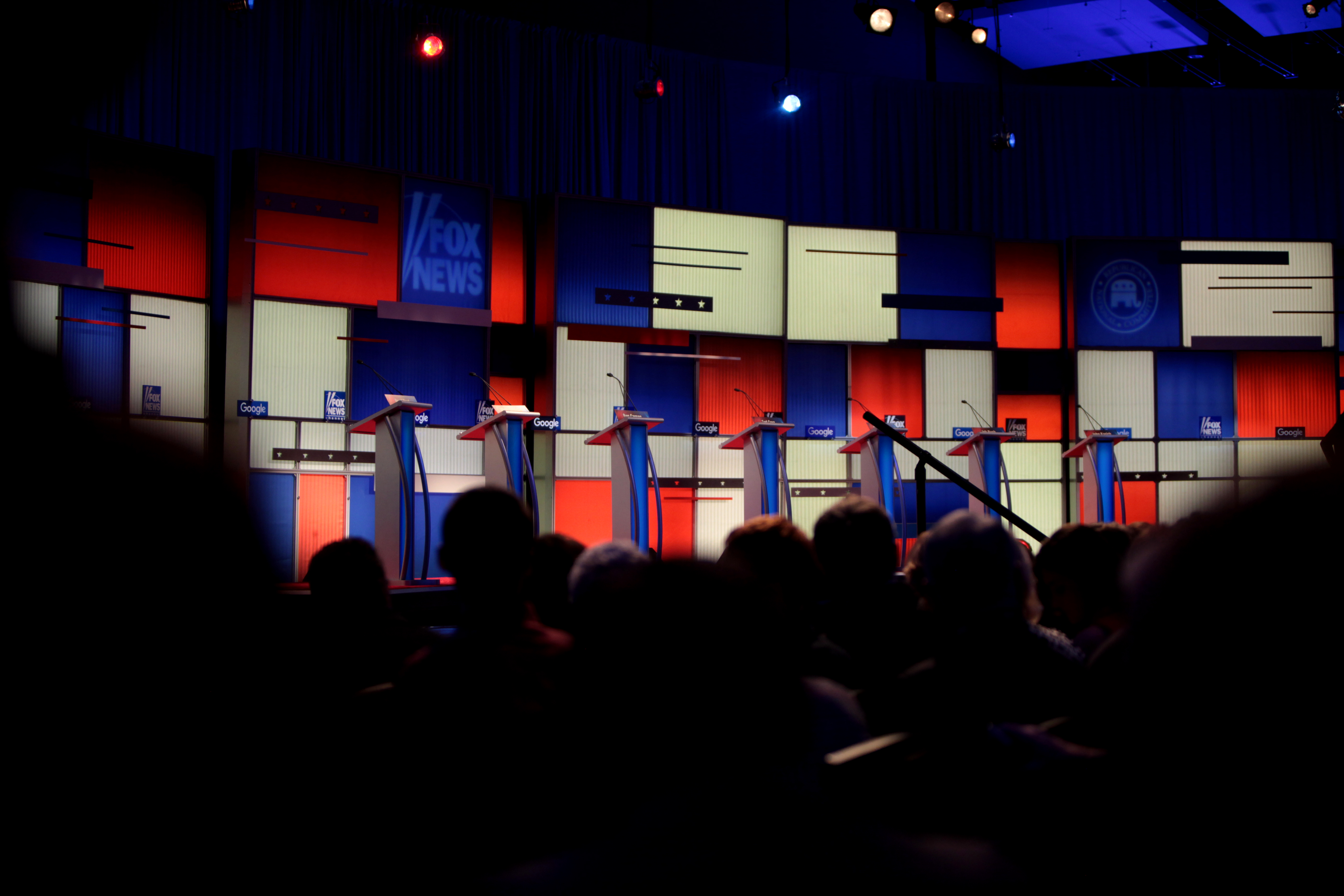 An empty debate stage with podiums and an audience