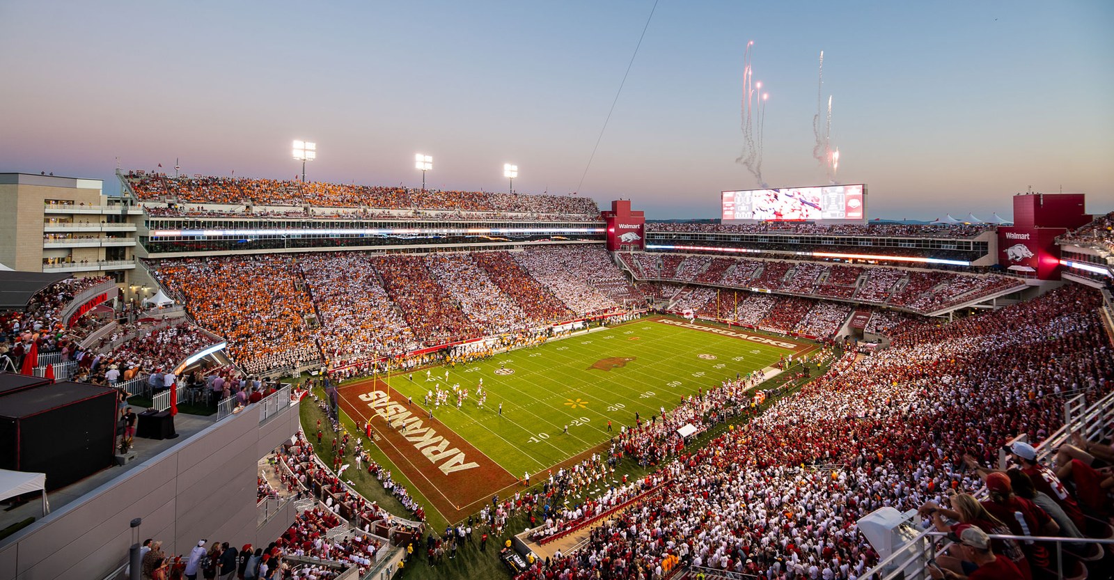 Razorback Stadium lit up at night on a game day in Fayetteville.