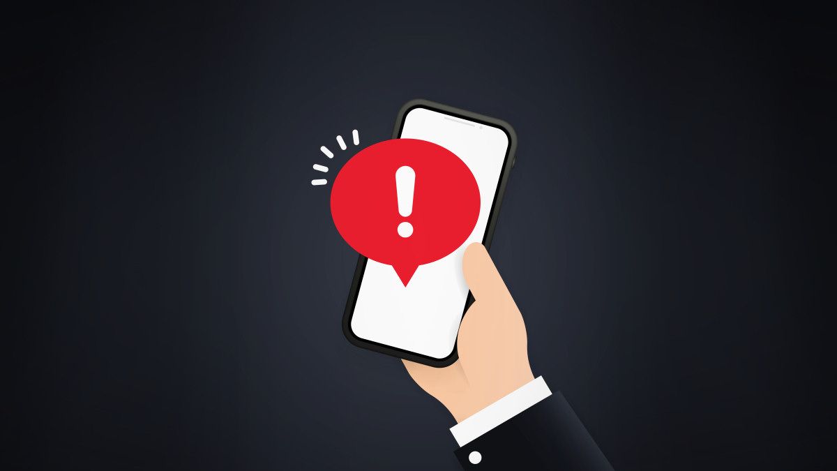 A hand holding a smartphone showing app notifications on screen