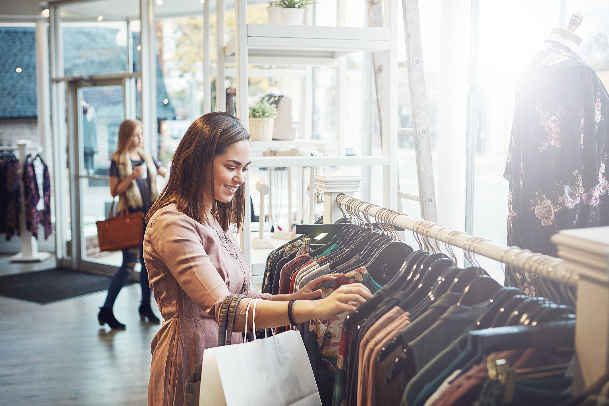 A customer shopping for clothes in a modern retail store