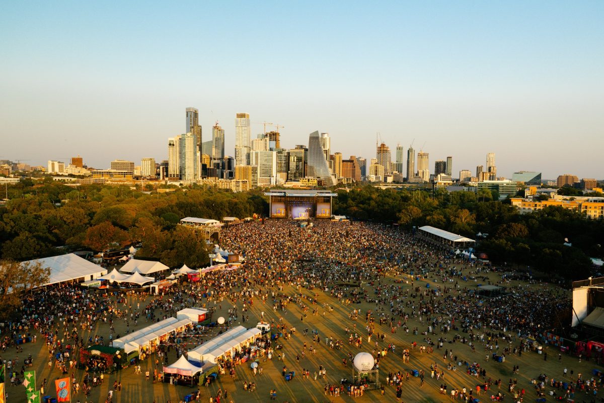 Aerial view of the Austin City Limits festival grounds at Zilker Park, with the downtown Austin skyline in the distance