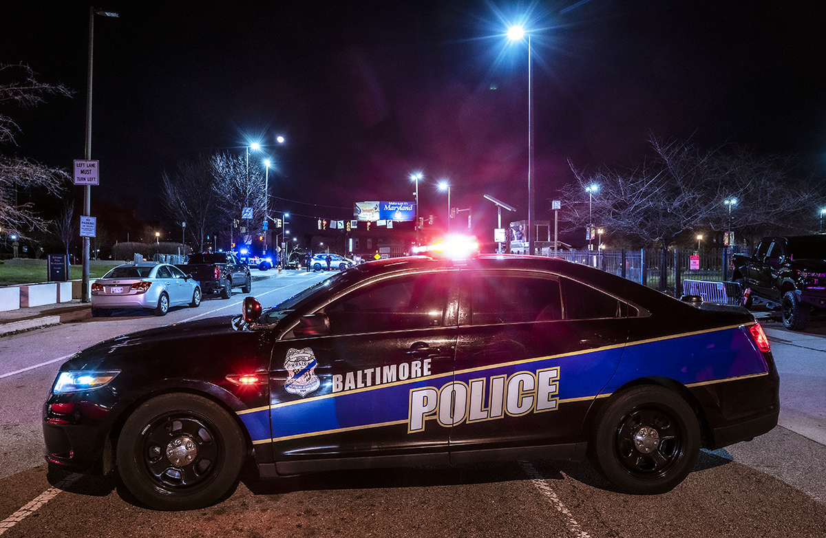 Baltimore police officers on patrol at night