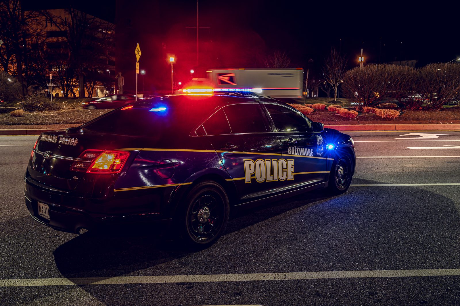 A Baltimore Police patrol car with emergency lights activated