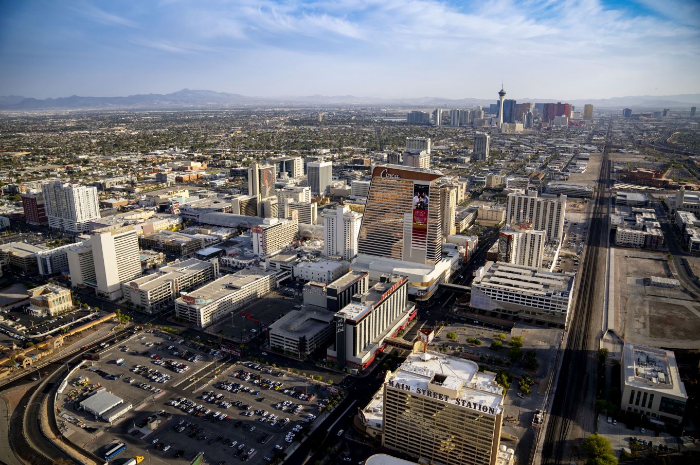 The Las Vegas skyline in bright daylight, with the Strip's casino resorts visible across the valley