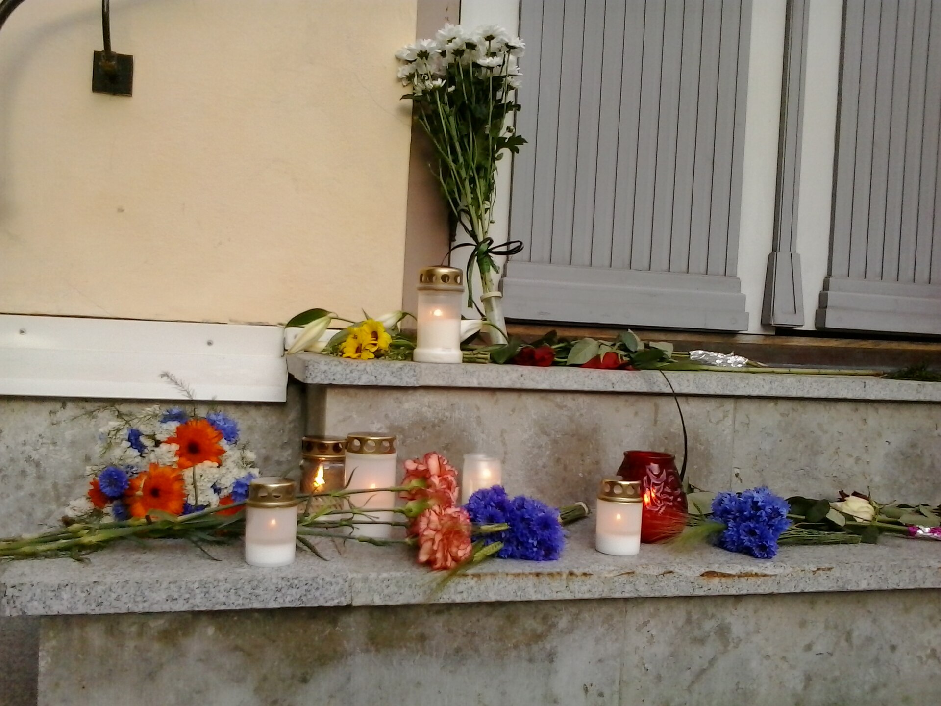 Flowers and candles left at a memorial (file photo)