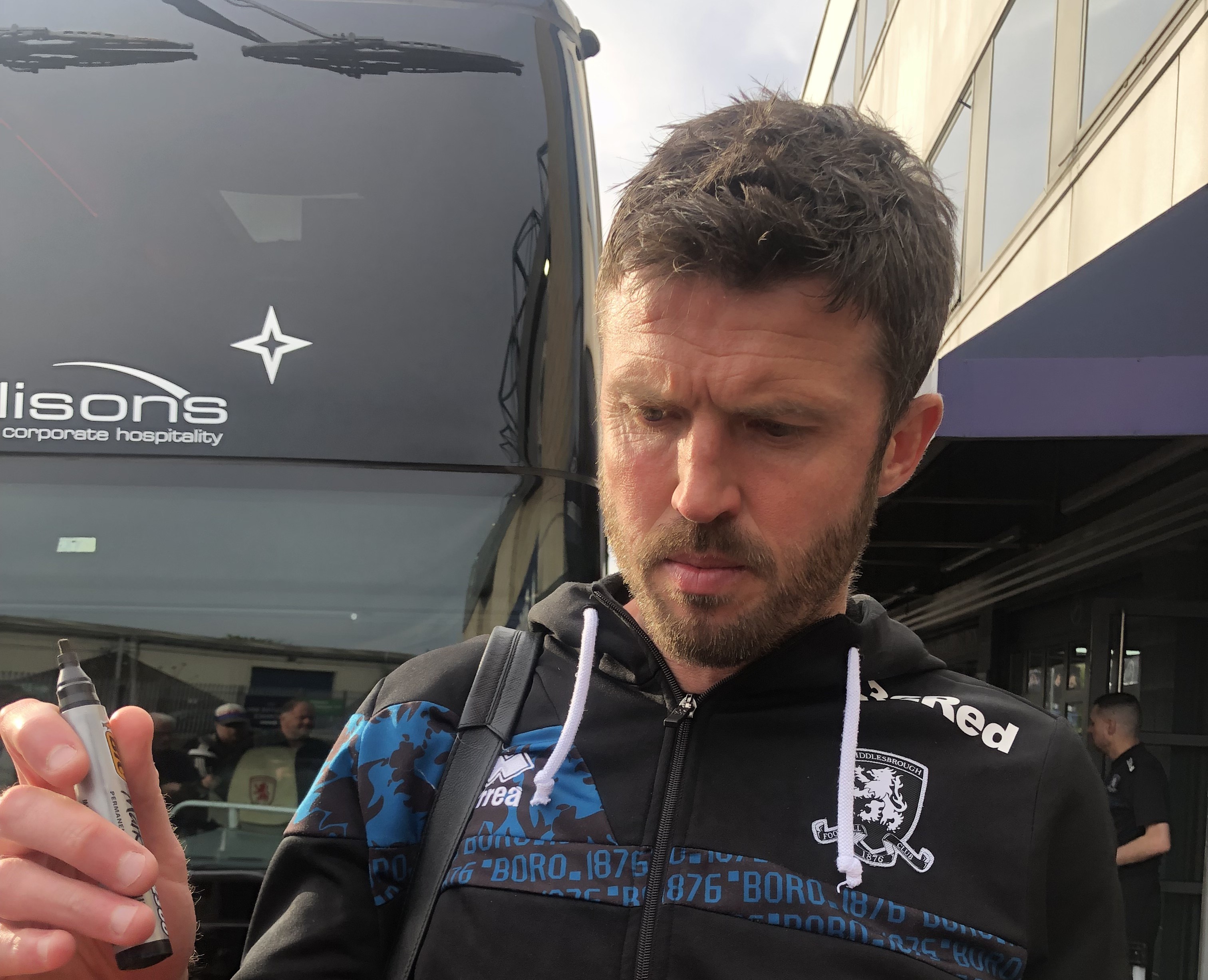 Michael Carrick signing autographs beside a team bus during his spell as Middlesbrough manager — April 2025 file photo