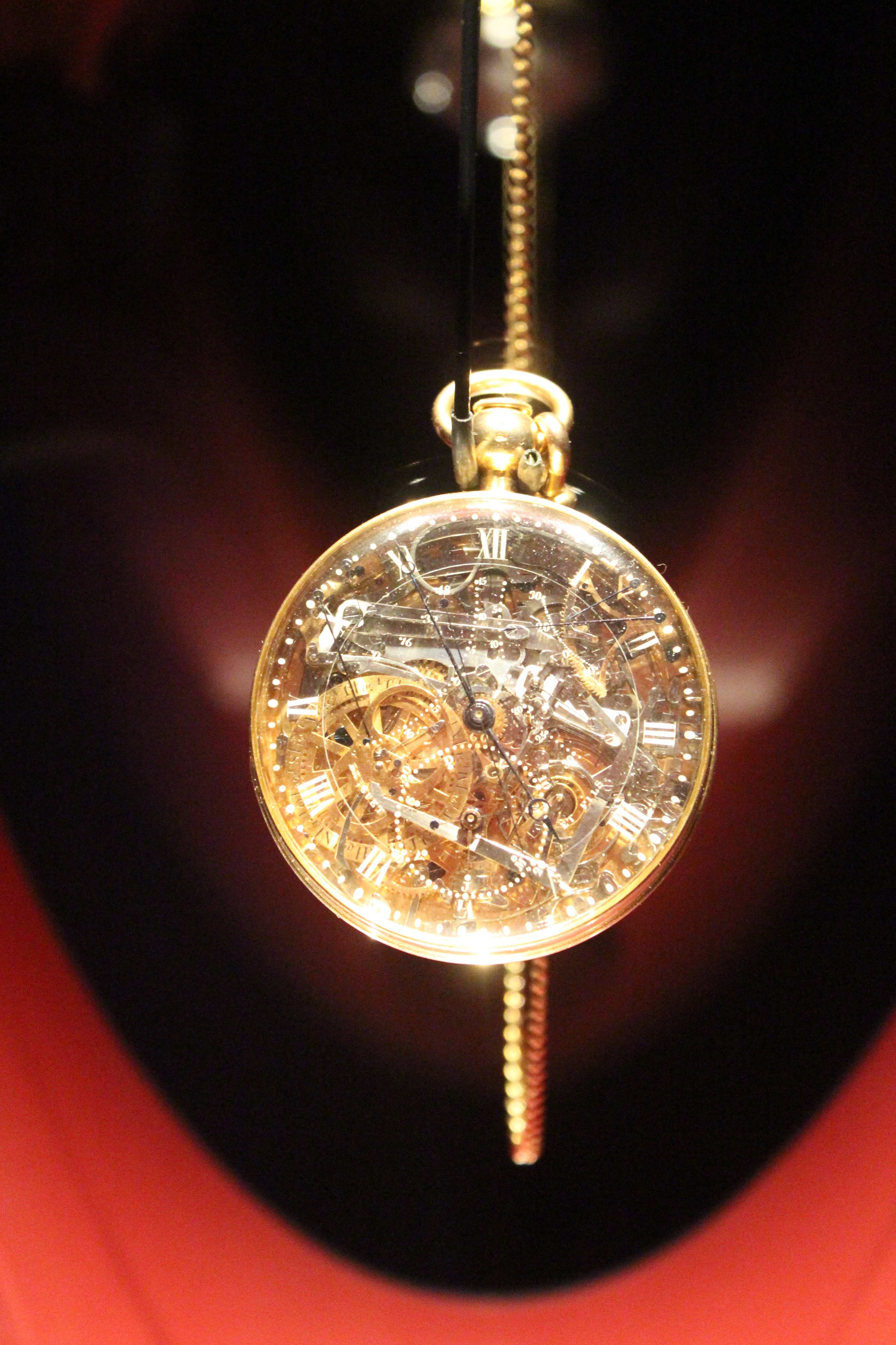 Close view of Breguet No. 160 — calendar rings, gears and hands visible through the rock-crystal dial.