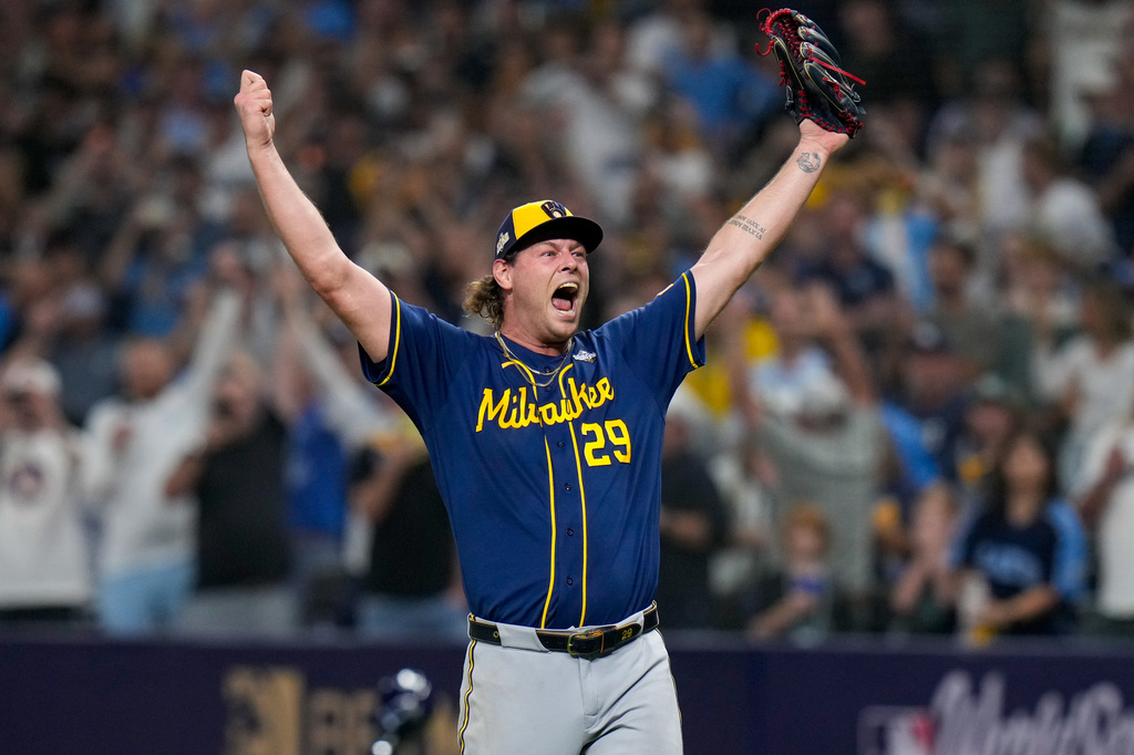 Trevor Megill of the Milwaukee Brewers, arms raised and roaring, celebrates after recording the final out of World Series Game 5 at Tropicana Field — Milwaukee 4, Tampa Bay 1, the Brewers' first World Series championship