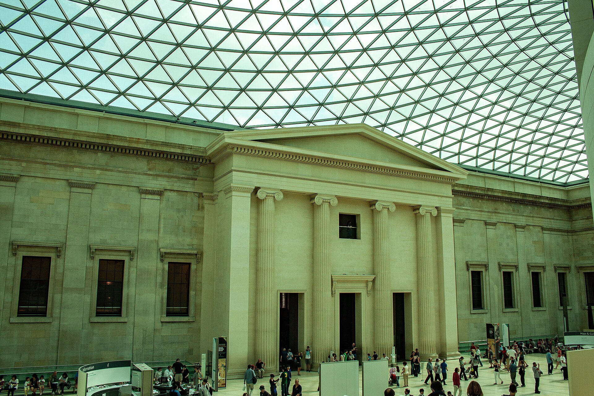 Daylight streaming through the glass roof of the British Museum's Great Court, with visitors below