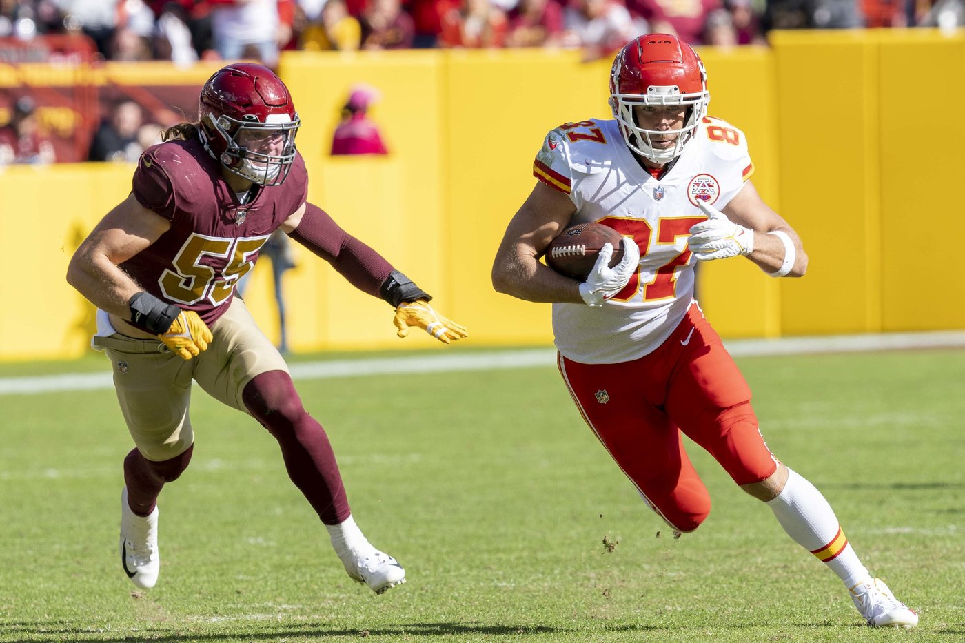 Travis Kelce running with the football during a game