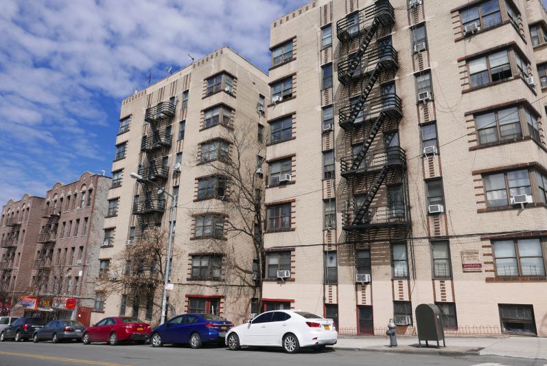 A Bronx residential street with apartment buildings in daylight