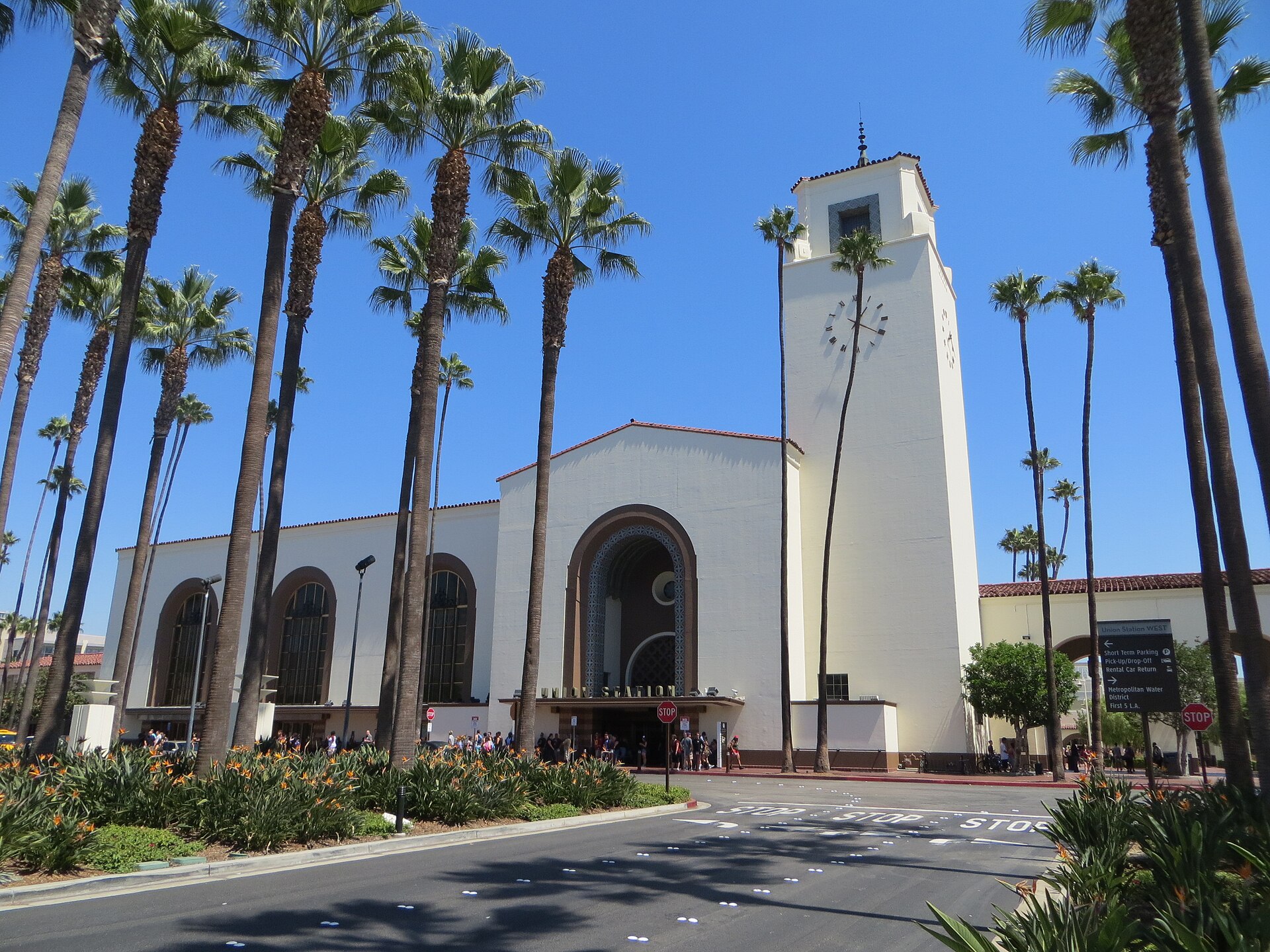 Los Angeles Union Station facade with palm trees under a clear blue sky
