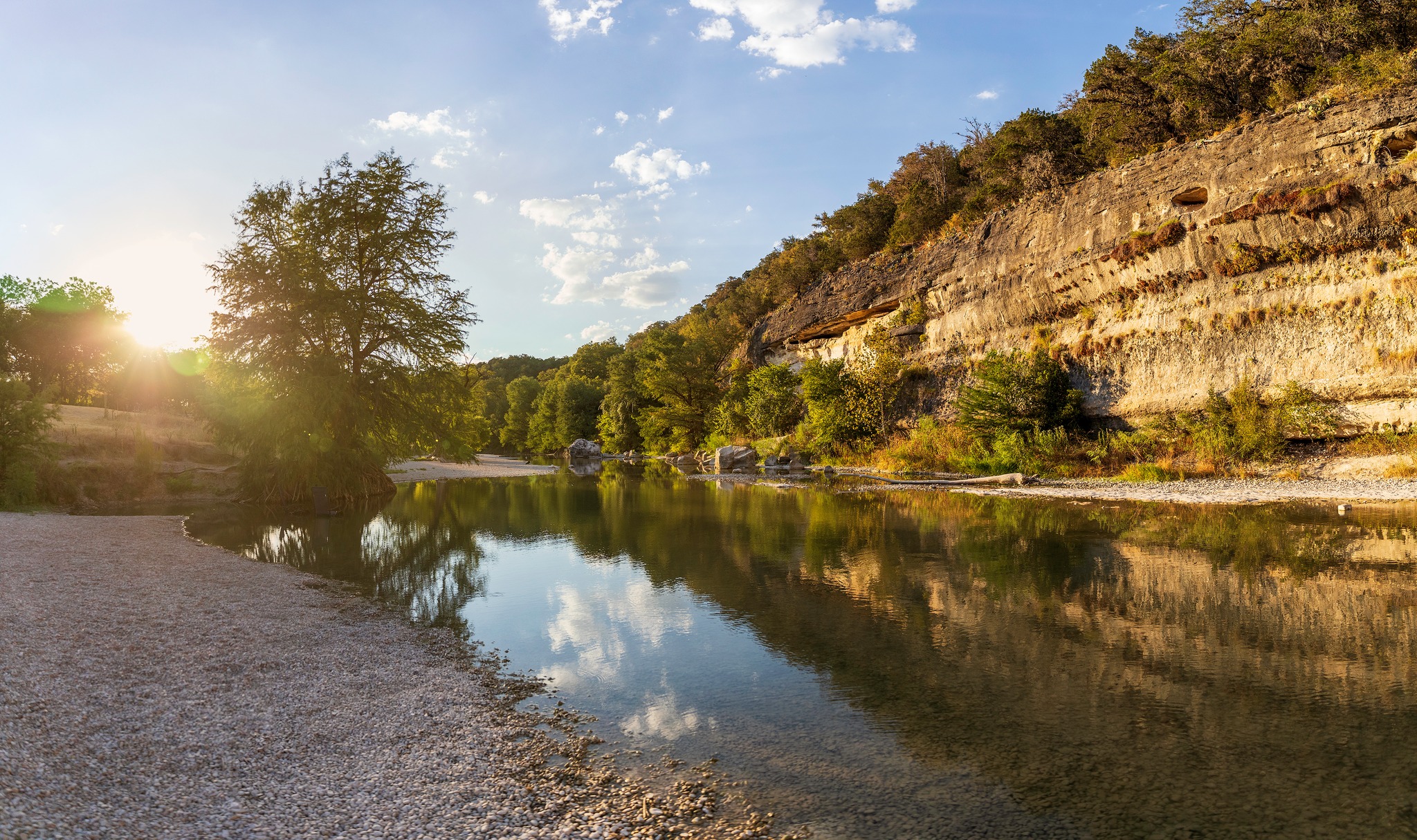 The Guadalupe River at golden hour, winding past limestone bluffs in the Texas Hill Country.