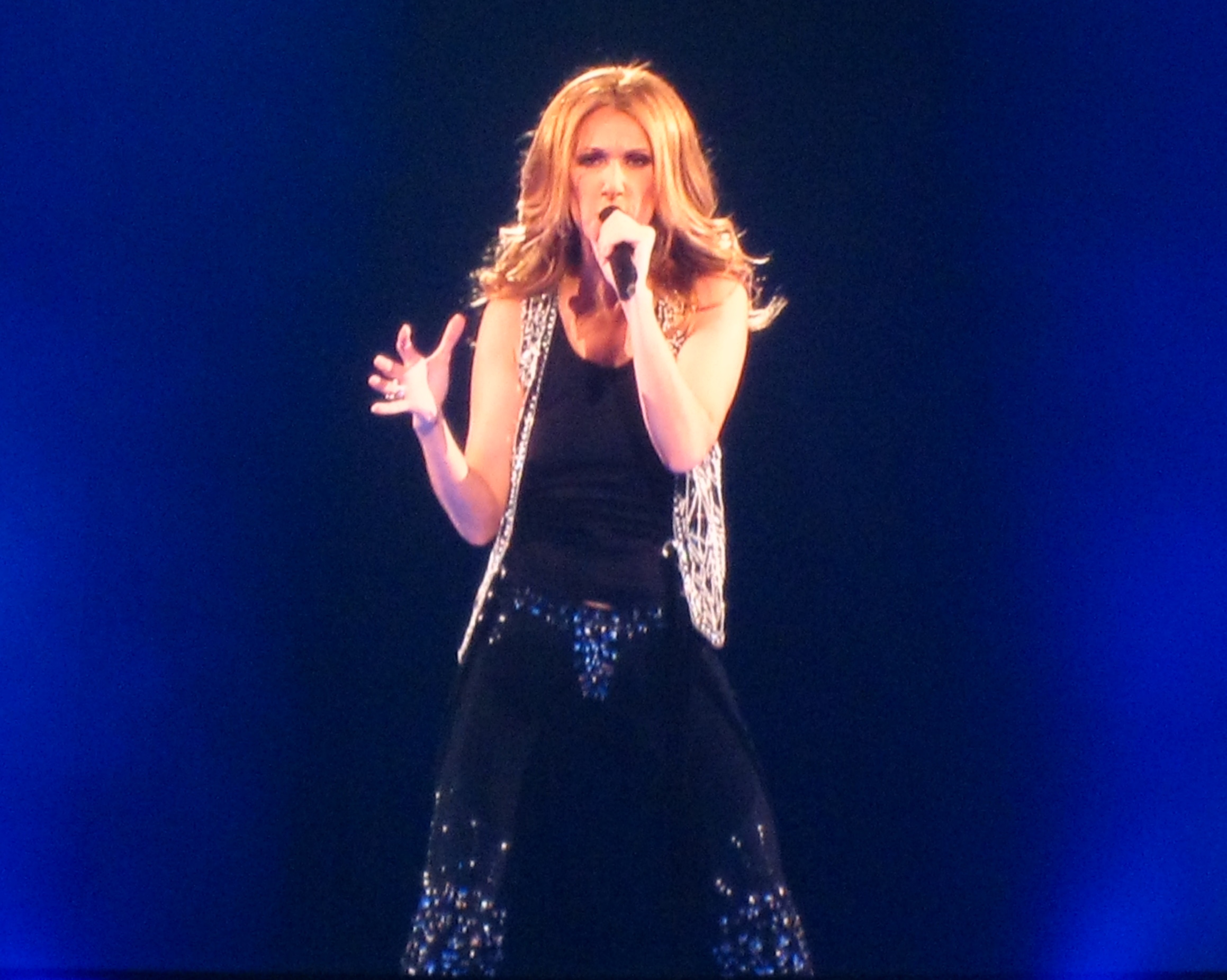 Celine Dion singing live in concert, microphone raised — file photo from 2008