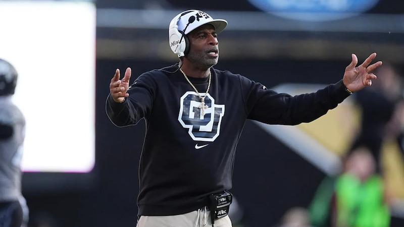 Colorado head coach Deion Sanders on the sideline in a CU black sweatshirt, in the week the Buffs' alleged playbook leak surfaced