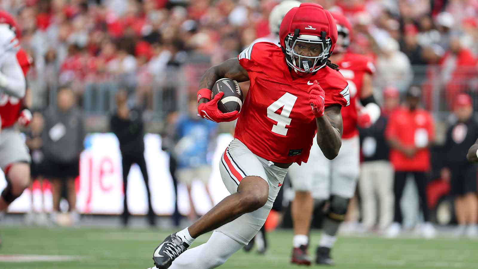 Ohio State receiver Jeremiah Smith running with the football in scarlet