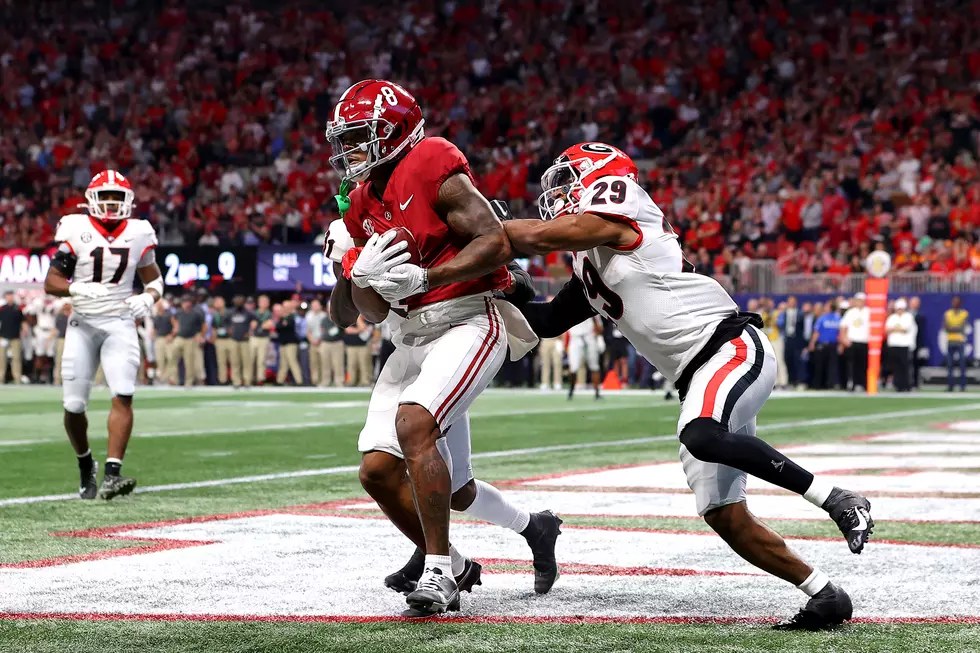 An Alabama ball carrier takes on a Georgia defender during game action