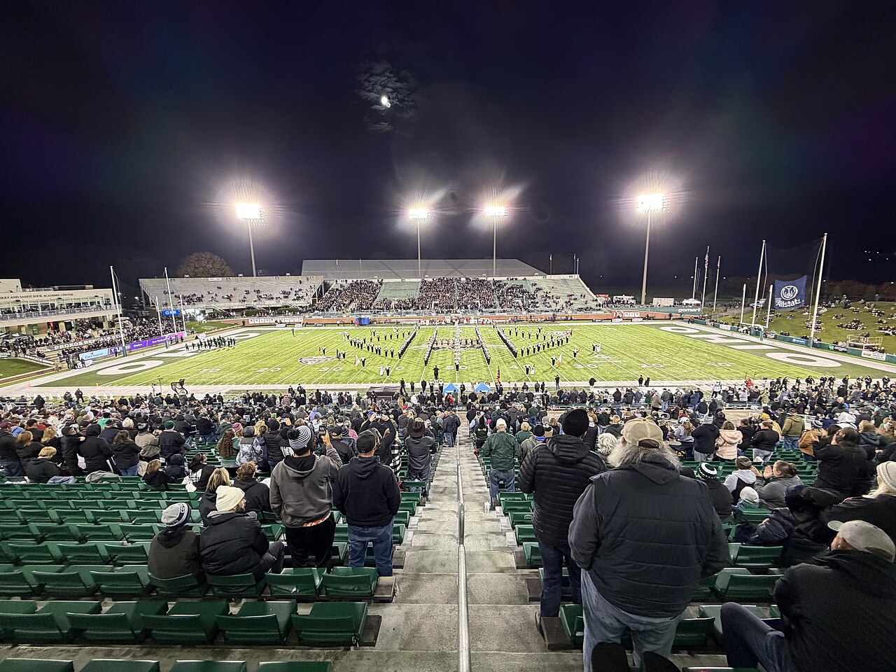 A packed college football stadium under the lights, with a 24-team playoff potentially on the way