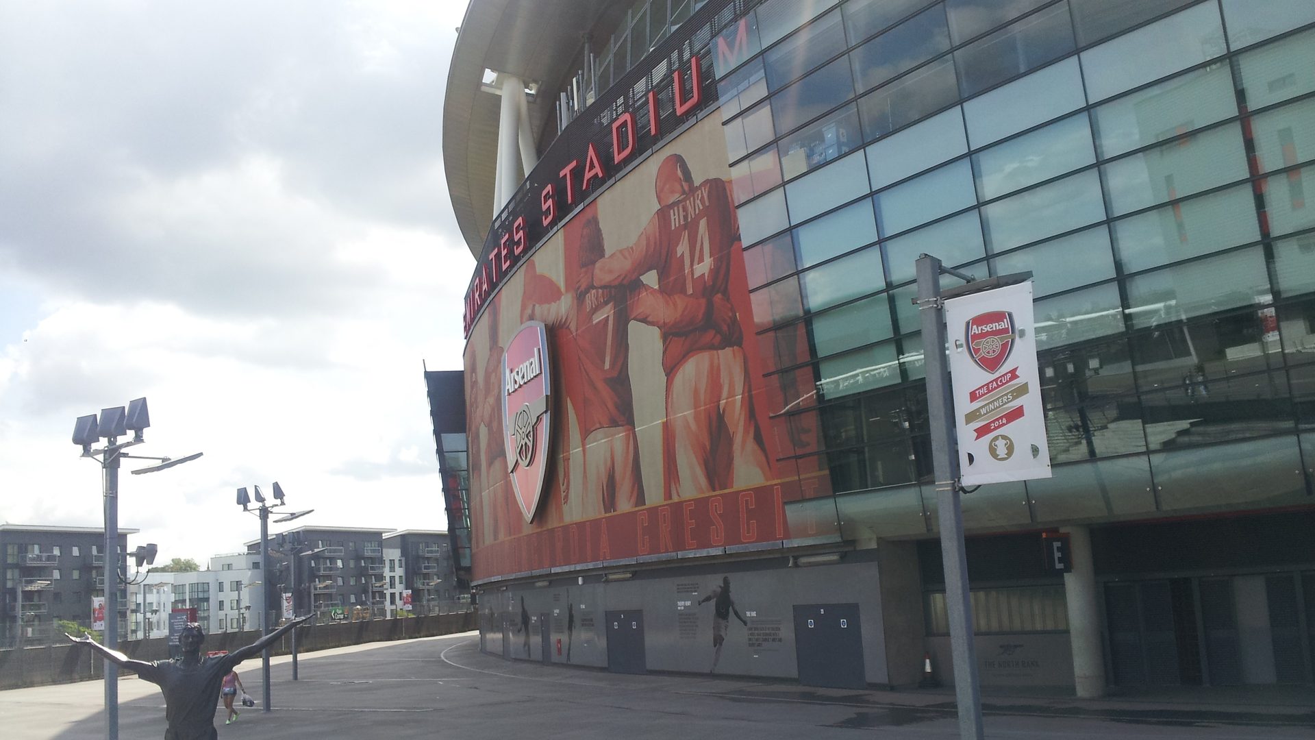 The Emirates Stadium in London, home of Arsenal, with the Thierry Henry statue outside