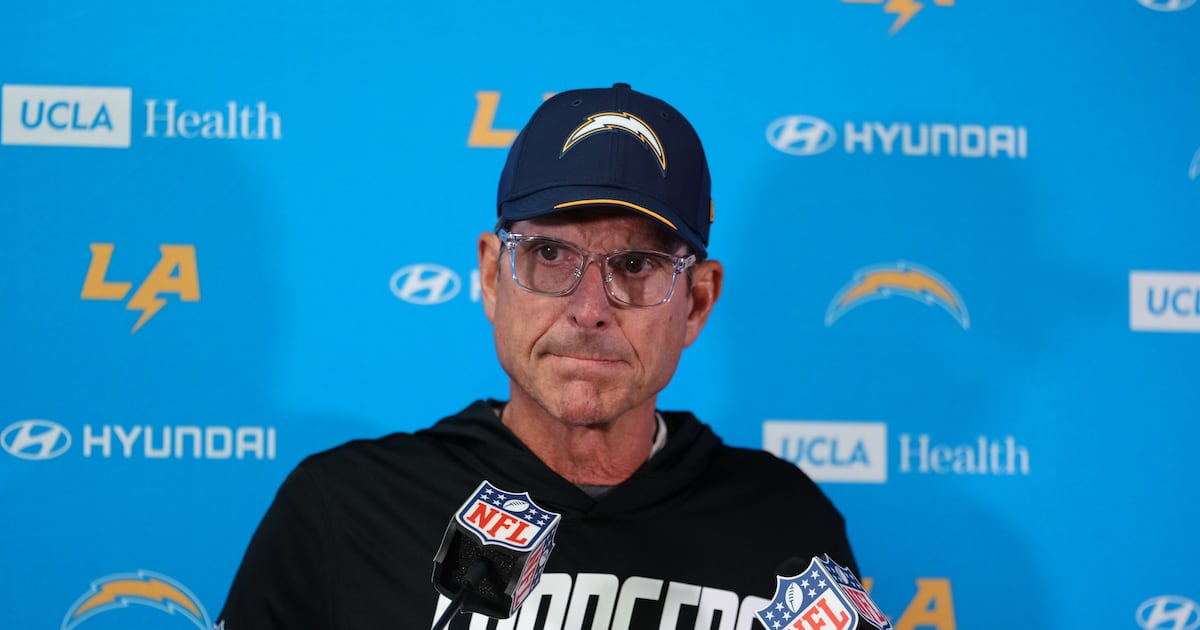 Los Angeles Chargers head coach Jim Harbaugh listens to a question during a news conference after the game against the Kansas City Chiefs in Kansas City on Sunday, Oct. 18, 2026