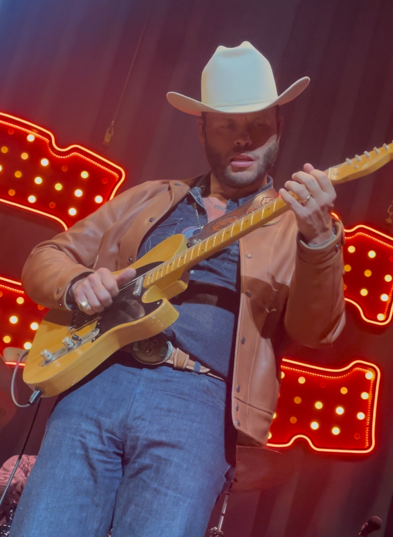 Charley Crockett performing live with his guitar at the Classic Center in Athens, GA — the Americana singer headlines his self-curated 'Texas in the Music City' concert at the Grand Ole Opry tonight.