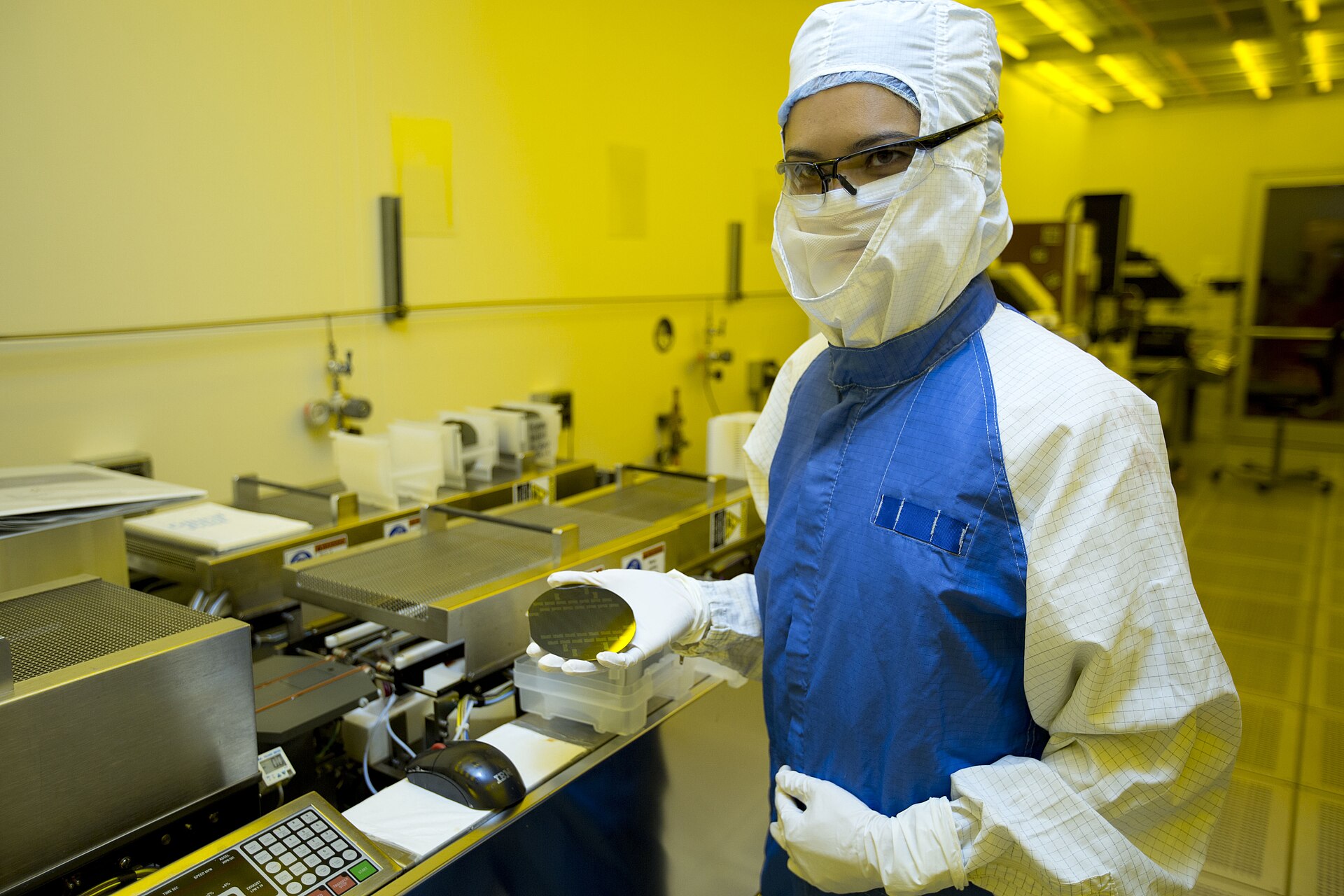 A researcher holding a silicon wafer in a cleanroom (file photo)