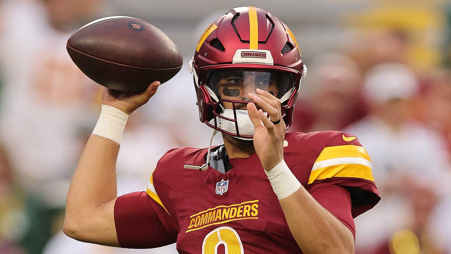 Washington Commanders quarterback Marcus Mariota (8) in the burgundy home uniform.