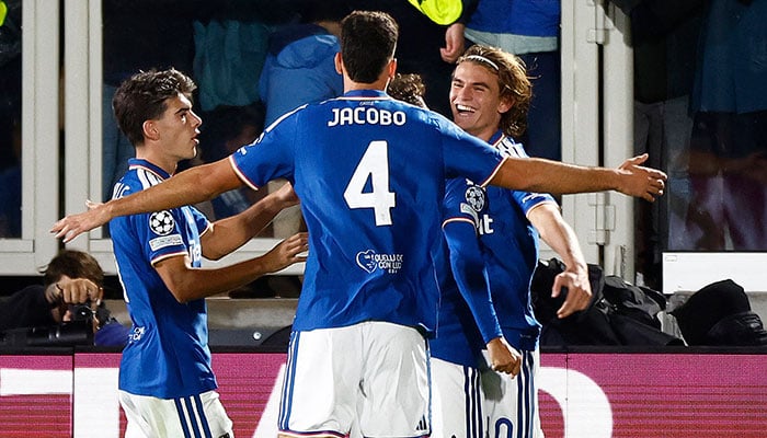 Como players, including Jacobo Ramon (4), celebrate during the 4-1 Champions League win over Manchester United at Stadio Giuseppe Sinigaglia