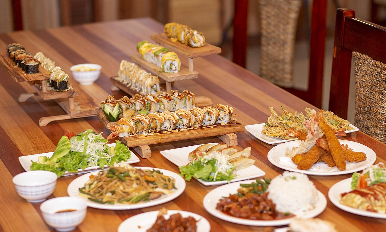 A platter of sushi rolls in bright daylight