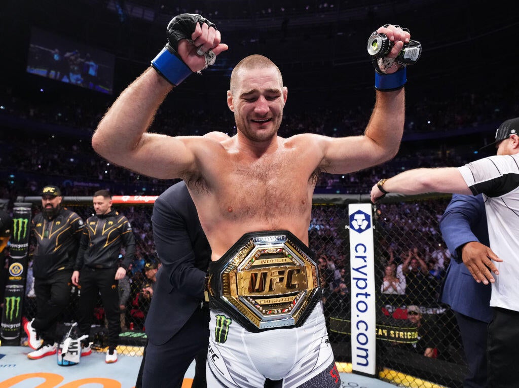 Sean Strickland celebrates with the UFC middleweight championship belt