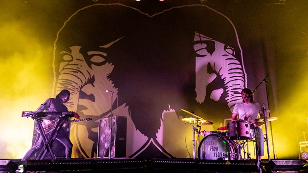 Death from Above 1979 performing live on a brightly lit concert stage