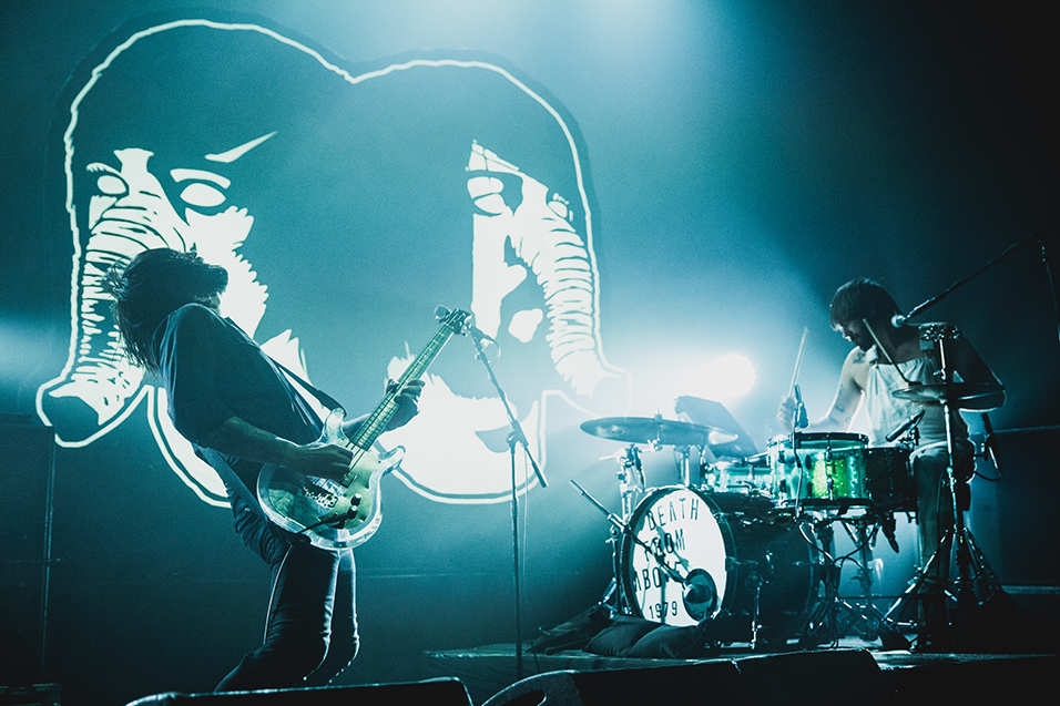 Death from Above 1979 performing live, bathed in stage light