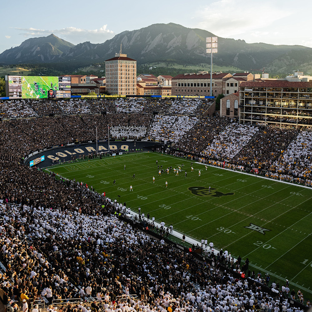 Folsom Field packed for a Colorado game with the Flatirons rising behind the stadium