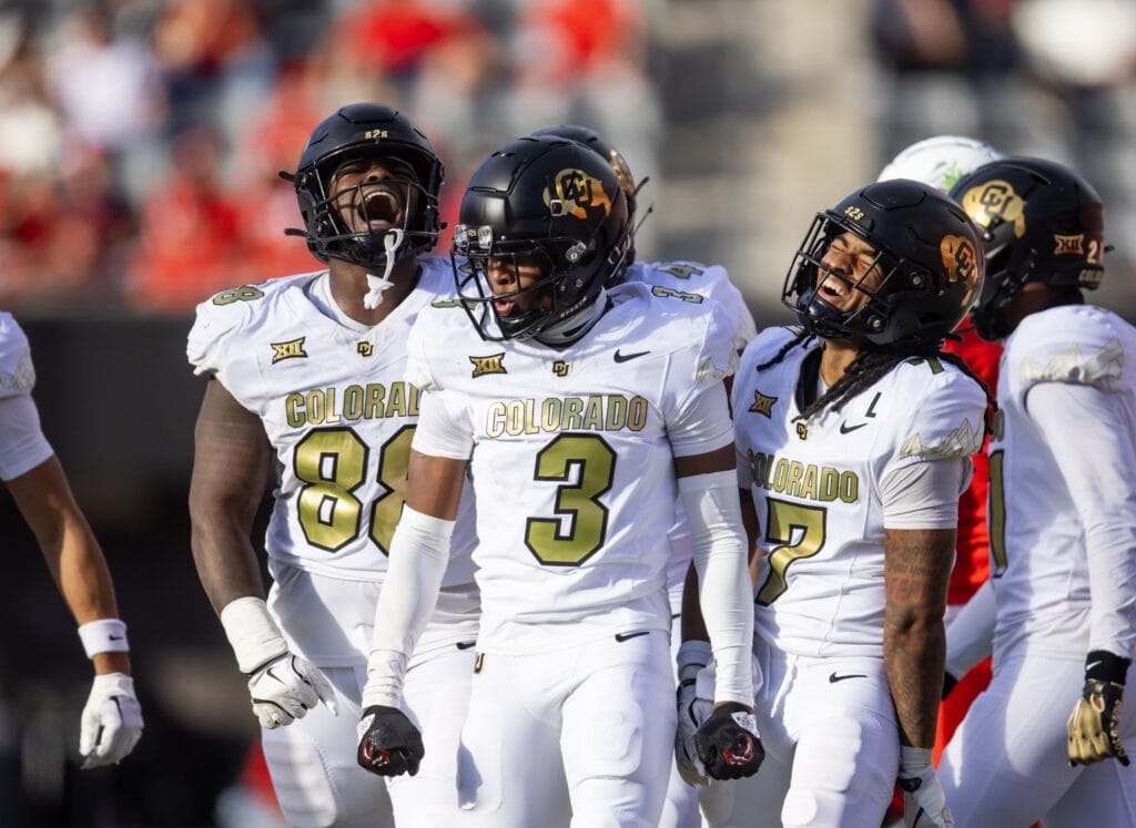 Colorado players in white uniforms celebrating on the field