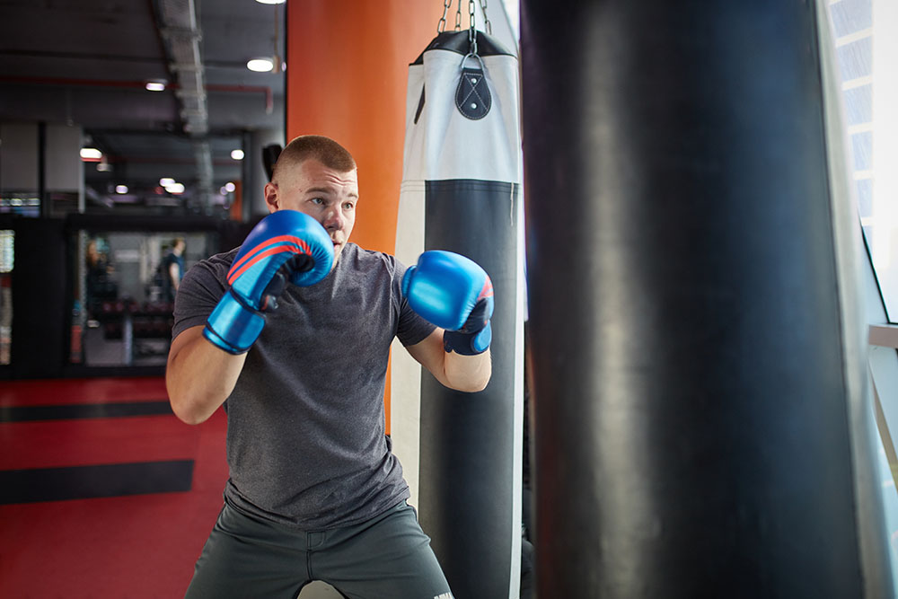 A boxer working the heavy bag in training