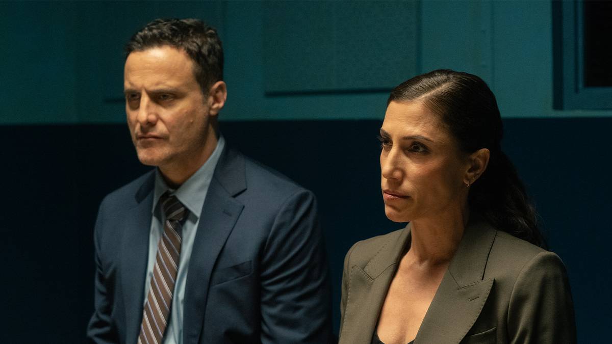 Two NYPD detectives in the Dexter: Resurrection season 2 premiere — a man in a suit and tie beside a woman in a blazer