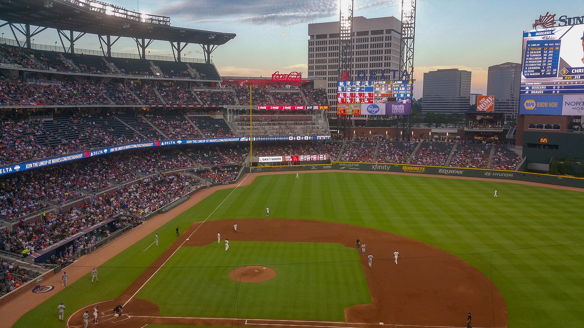 A wide view of a Dodgers-Braves game at Truist Park in Atlanta at sunset